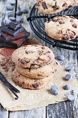 Chocolate cookies with chocolate chips on a rustic wooden table