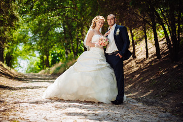 Bride with Groom at wedding Day walking Outdoors on spring