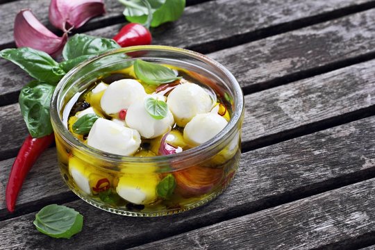 Mozzarella marinated with garlic, spices and basil in olive oil