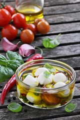 Mozzarella marinated with garlic, spices and basil in olive oil