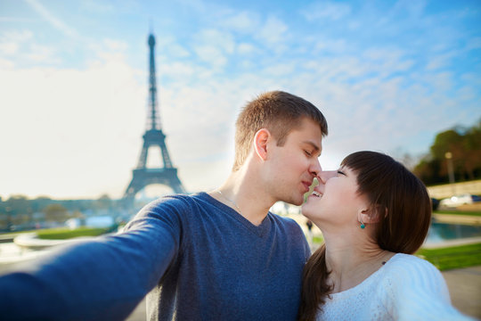 Tourists taking selfie near the Eiffel tower