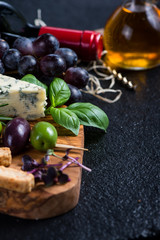 Food background,rustic board with cheese herbs and wine