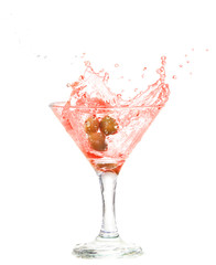 Splash from olive in a glass of cocktail, isolated 
