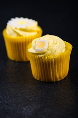 Lemon cupkace decorated with icing on dark background