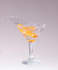 cocktail in a martini glass on a white background with fruit