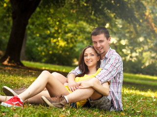Affectionate young couple sitting in park