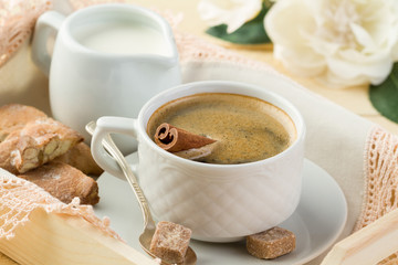 Morning coffee with cinnamon, milk and cookies