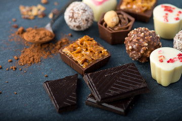selection of artisan chocolates praline on black background