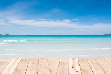 Fototapeta na wymiar Wood terrace on beach blue sky