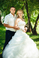 Bride with Groom at wedding Day walking Outdoors on spring