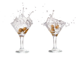 Splash from olive in a glass of cocktail, isolated 