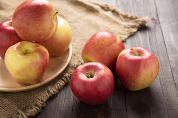 Fresh ripe red apples on wooden background