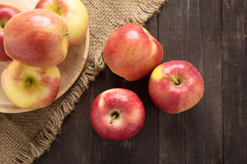 Fresh ripe red apples on wooden background