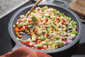 Mixing vegetables on a pan