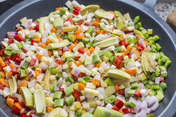 Cooking boiling Mediterranean veggies on a pan