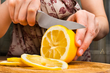 hands slicing lemon