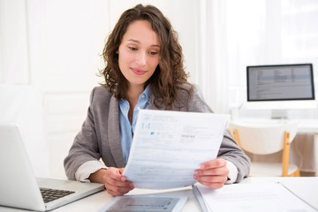 Young attractive woman doing paperwork