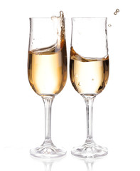 White wine pouring from the bottle intro the glass on white 