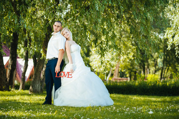 Bride with Groom at wedding Day walking Outdoors on spring