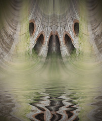 ancient wall with tunnels reflected on water © Jorge Anastacio