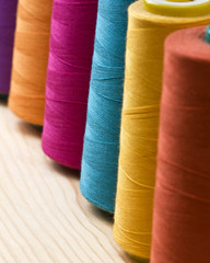 several of multi-colored spool of threads
