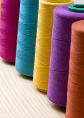 several of multi-colored spool of threads