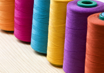 several of multi-colored spool of threads