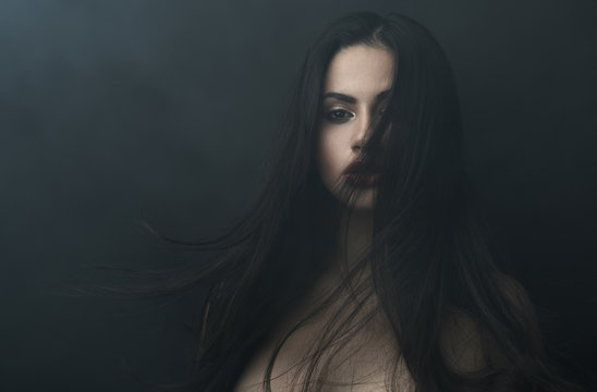 mysterious portrait of a girl in  dark  fog