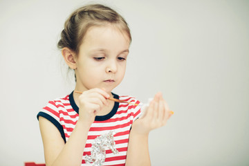 little 6 years girl with paint toy