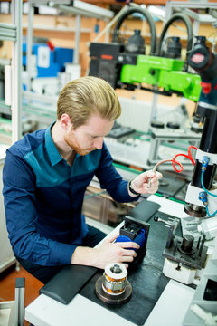 Young man in electronics workshop