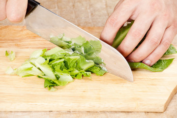 Cook cuts the lettuce