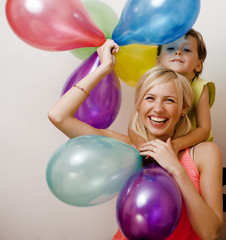 pretty family with color balloons on white background, blond wom