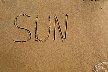 The word sun drawn in sand