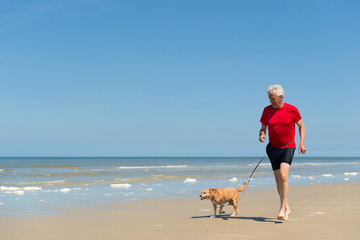 Running with dog at the beach