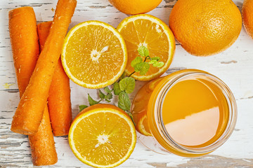 Oranges carrots juice on a vintage table