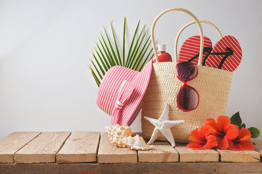 Summer Beach Bag And Hibiscus Flowers On Wooden Table Concept