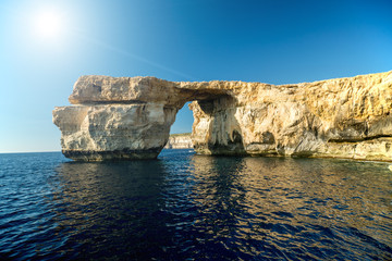Azure Window, famous stone arch on Gozo island with reflection,