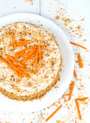 Gourmet homemade sponge cake with carrot slices and walnut
