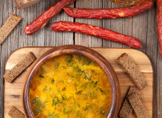 Bowl of rustic traditional chicken broth noodle soup on vintage 