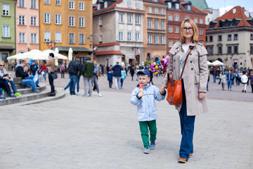 Mam and son walking in old town Warsaw, Poland