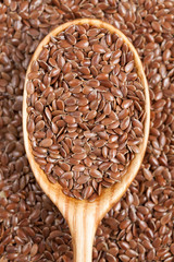 Healthy little brown flax seeds super foods  in wooden spoon