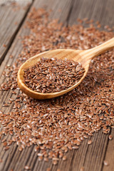 Natural raw flax seeds nutritious food in spoon on wooden vintag