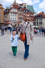 Mam and son walking in old town Warsaw, Poland