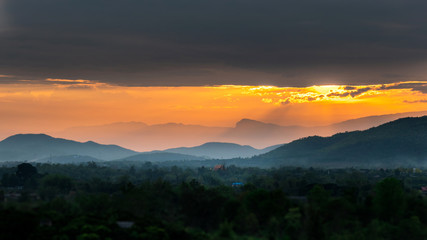 Obraz premium Colorful sunset over the mountain hills
