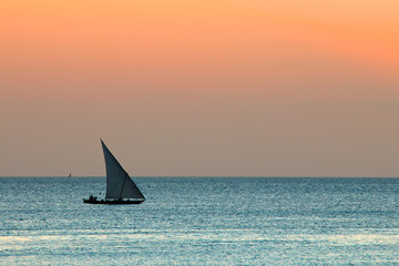 Obraz na płótnie Canvas Sailboat on water at sunset, Zanzibar