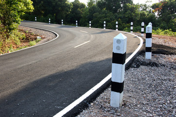 Stone pillars prevent accidents on the road curved.