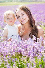 Mother and daughter in field of lavender flowers