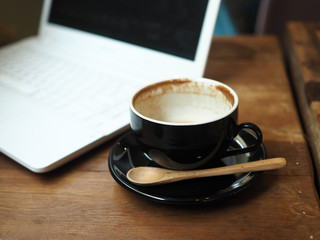 cup of coffee latte art on the wood desk