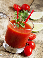 Red cocktail with tomato juice, lime and salt, selective focus