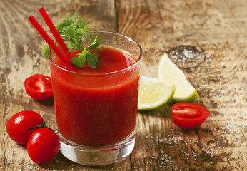 Red cocktail with tomato juice, lime and salt, selective focus